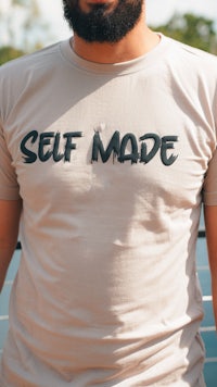 a man wearing a t - shirt that says self made